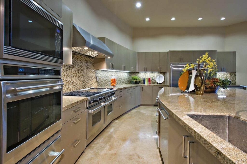 Modern kitchen featuring built-in stainless steel appliances integrated with custom cabinetry.