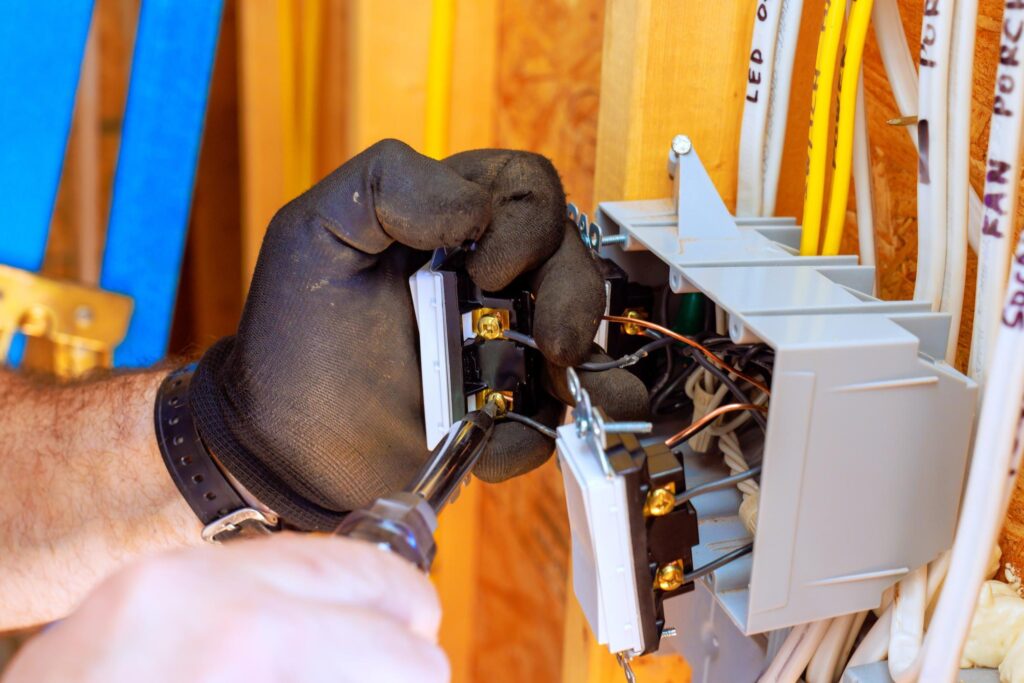Electrician replacing circuit breakers to improve home electrical safety.