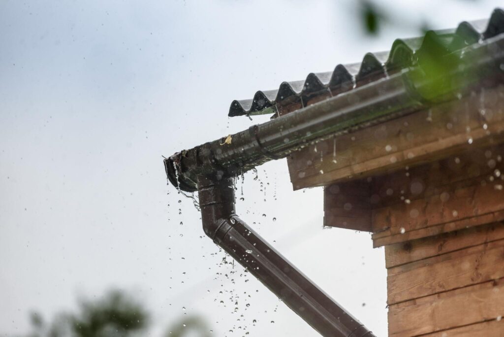 Clean gutters and downspouts directing rainwater away from the home's foundation.