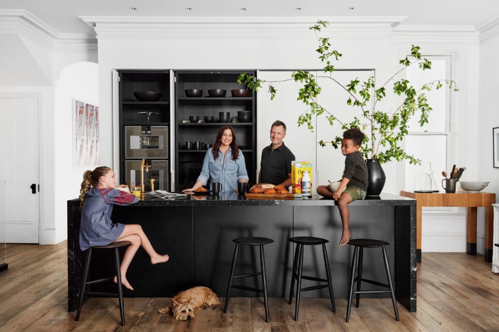 Family gathered around a spacious kitchen island in a modern open-concept home.