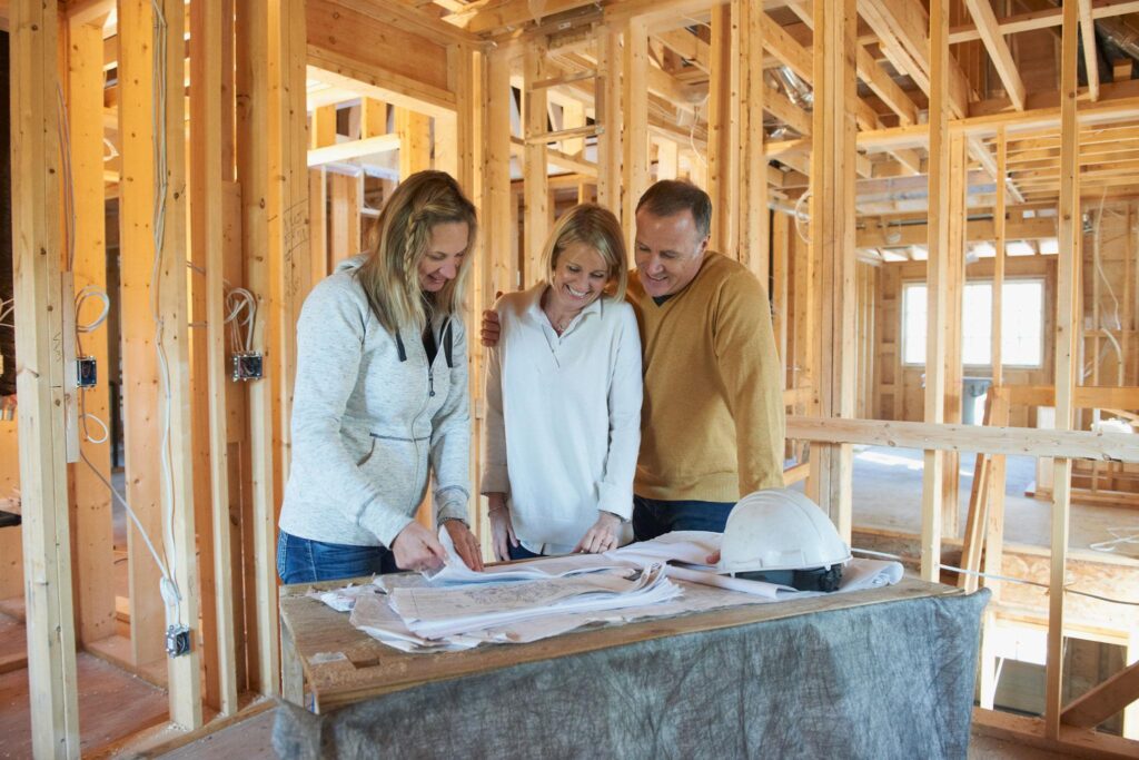 Professional contractor reviewing architectural plans for a custom home addition.