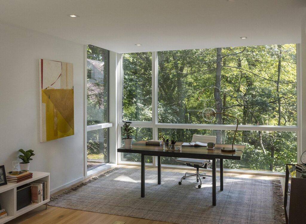Dedicated home office addition with large windows designed for productivity.