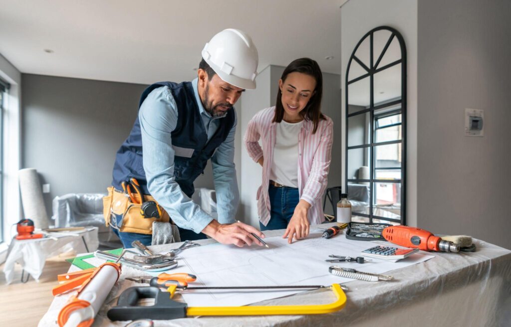 Contractor reviewing building plans and permits for a residential renovation project
