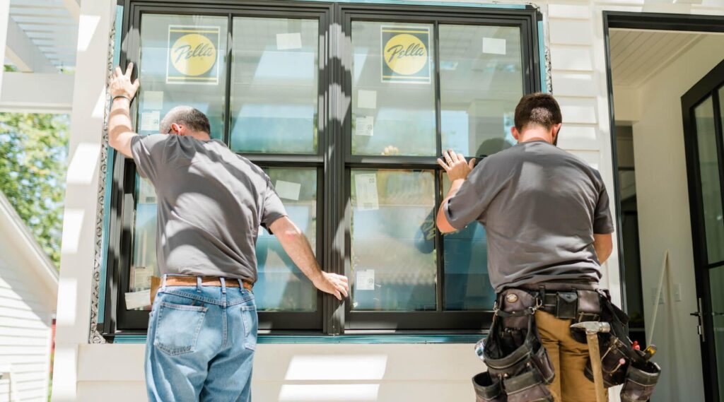 Contractor installing impact-resistant windows to strengthen a Florida home before hurricane season.