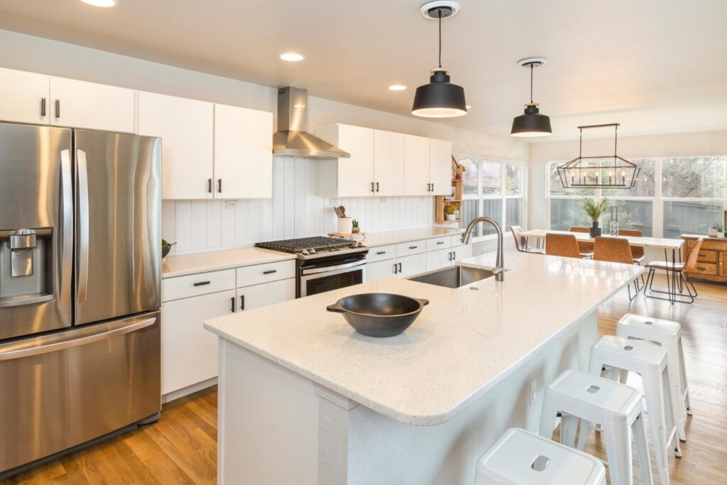 Modern kitchen featuring quartz countertops and stainless steel appliances that appeal to homebuyers.