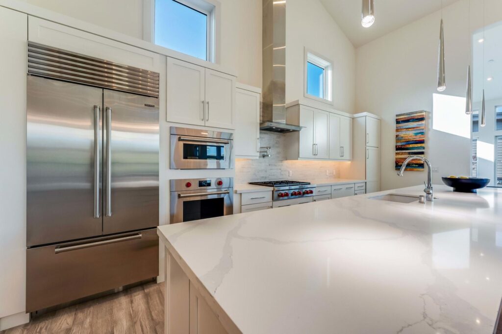 Luxury kitchen with modern stainless steel appliances that increase home value and buyer appeal.