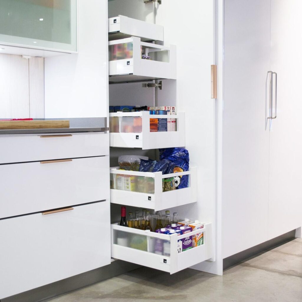 Modern custom kitchen cabinets featuring pull-out shelves, organized drawers, and built-in storage