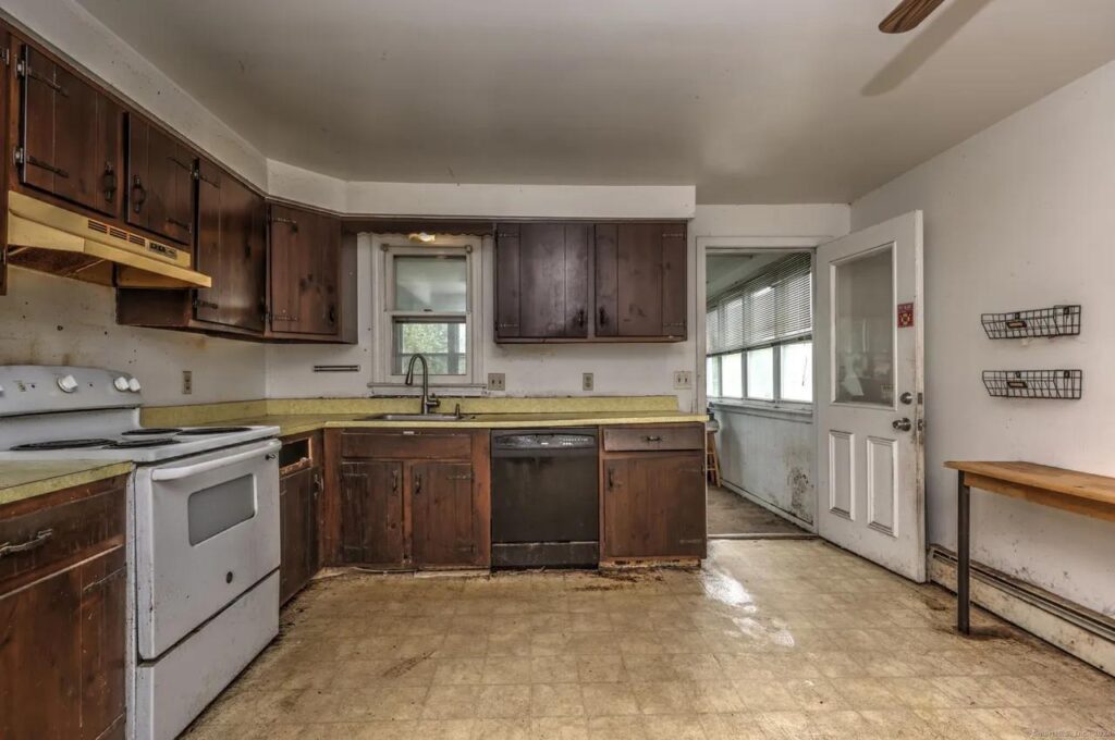 Outdated kitchen with aging cabinets and countertops before preparing a home for sale.