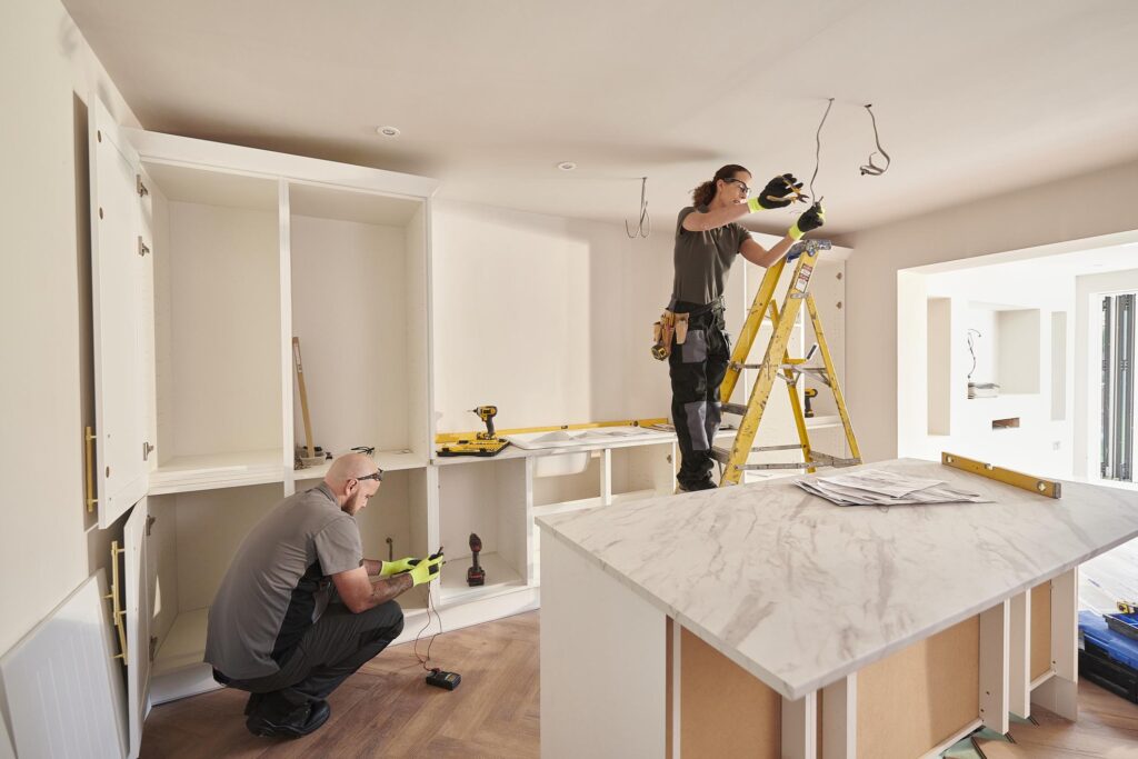 Professional contractors completing electrical and plumbing work during a home renovation