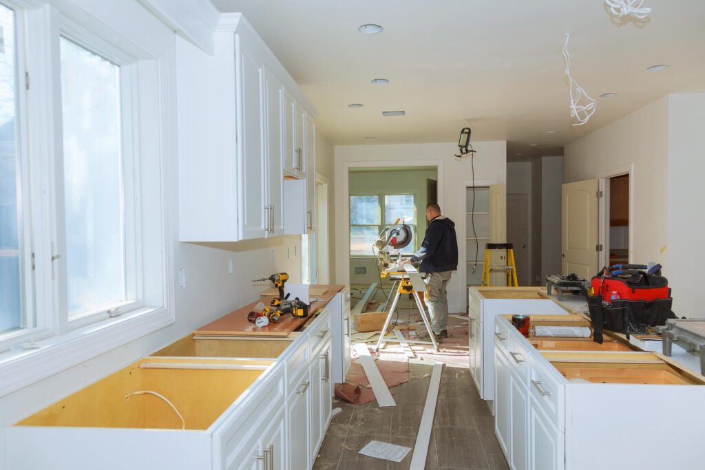 Skilled contractor completing detailed interior finishing work for a professionally built home addition.