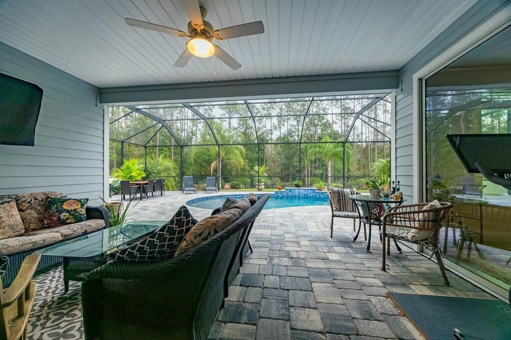 Florida screened lanai with comfortable seating overlooking a pool