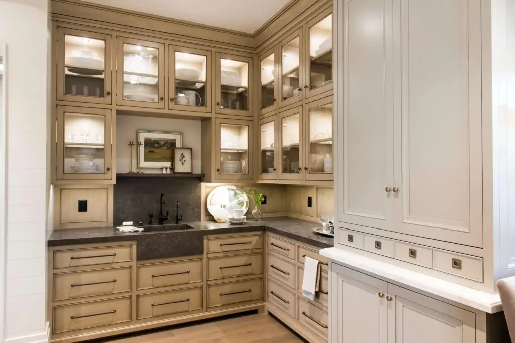 Custom white oak kitchen cabinetry with hidden pantry storage and premium shaker-style cabinet doors.