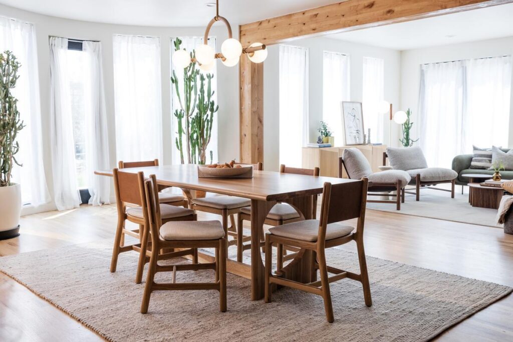 Contemporary dining room featuring a solid wood dining table, upholstered chairs, and elegant pendant lighting.